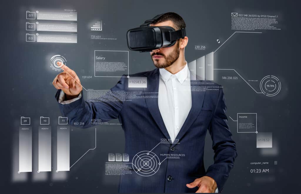 Male in a suit with virtual reality glasses on his head working in virtual financial world.