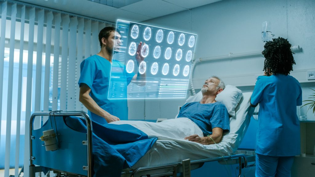 Futuristic Medical Ward with Sick Patient Lying in Bed and Doctor using Gestures and Augmented Reality Interface. Doctor Looks at Brain Scans and Medical History of the Patient.