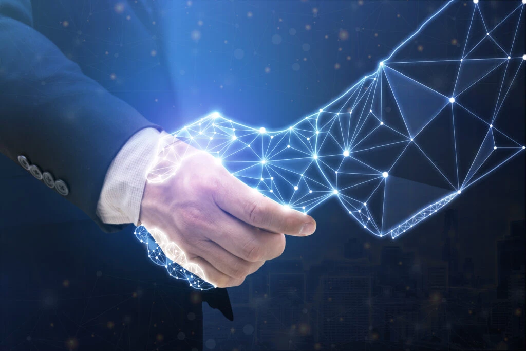 Businessperson shaking hand with digital partner over futuristic background. Artificial intelligence and machine learning process for 4th industrial revolution.